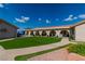 Spacious backyard featuring artificial turf, mature landscaping, and a covered patio with arched columns at 465 E Robindale Rd, Las Vegas, NV 89123