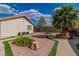 Lush backyard with gravel accents, mature landscaping, and walkways leading around the property's perimeter at 465 E Robindale Rd, Las Vegas, NV 89123