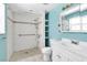 Clean bathroom featuring a walk-in shower, grab bars, and a classic white vanity with ample counter space at 465 E Robindale Rd, Las Vegas, NV 89123