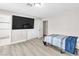 Cozy bedroom with wood-look floors, a large closet, and an ensuite bathroom offering convenience at 465 E Robindale Rd, Las Vegas, NV 89123