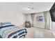 Inviting bedroom featuring a comfortable bed, accent chair, and a large window for natural light at 465 E Robindale Rd, Las Vegas, NV 89123