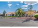 Attractive single-story home with a terra cotta roof, complemented by a lush palm tree and desert landscaping at 465 E Robindale Rd, Las Vegas, NV 89123