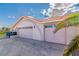 Attached two-car garage with matching doors for convenient access and increased parking at 465 E Robindale Rd, Las Vegas, NV 89123