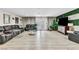 Large living room area with comfortable black couches, and modern interior design elements at 465 E Robindale Rd, Las Vegas, NV 89123