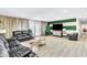 Comfortable living room area with leather couches, indoor plant life and neutral color scheme at 465 E Robindale Rd, Las Vegas, NV 89123