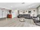 Spacious living room featuring modern light wood-look floors, leather sofas, and decor at 465 E Robindale Rd, Las Vegas, NV 89123
