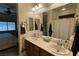Bathroom featuring double sinks, vanity, and a large mirror; bright, well-lit space at 4732 S Adriano Way, Pahrump, NV 89061