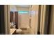 Bright bathroom featuring a tub/shower combo with neutral tile and classic fixtures at 4732 S Adriano Way, Pahrump, NV 89061