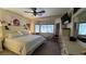Comfortable bedroom with neutral colors, large window, and ceiling fan at 4732 S Adriano Way, Pahrump, NV 89061