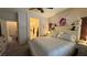 Cozy bedroom showcasing a bed, bathroom access, and neutral decor at 4732 S Adriano Way, Pahrump, NV 89061