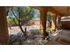 Inviting covered patio area features metal furniture, potted plants, and a view of the landscaped backyard at 4732 S Adriano Way, Pahrump, NV 89061