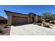 Beautiful single-story home with a two-car garage, stone accents, and well-maintained landscaping at 4732 S Adriano Way, Pahrump, NV 89061