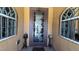 Charming front door with etched glass details, flanked by arched windows and ornamental decor at 4732 S Adriano Way, Pahrump, NV 89061