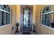 Charming front door with etched glass details, flanked by arched windows and ornamental decor at 4732 S Adriano Way, Pahrump, NV 89061