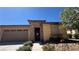 Inviting home with stone accents, desert landscaping, wrought iron gate, and two-car garage at 4732 S Adriano Way, Pahrump, NV 89061