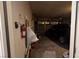 Spacious garage with a car, a fire extinguisher, storage items, and a roll up door at 4732 S Adriano Way, Pahrump, NV 89061