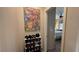 Hallway leading to the Primary bedroom with wood floors, art and shoe rack at 4732 S Adriano Way, Pahrump, NV 89061