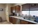 Kitchen featuring stainless appliances, granite counters and a double basin sink, with bright window and wood cabinets at 4732 S Adriano Way, Pahrump, NV 89061