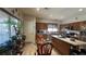 Bright kitchen featuring stainless appliances, warm wood cabinetry, and a glass top table with seating by a window at 4732 S Adriano Way, Pahrump, NV 89061