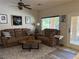 Cozy living room with comfortable seating, ceiling fan, and a door to the patio at 4732 S Adriano Way, Pahrump, NV 89061