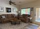 Cozy living room with comfortable seating, a decorative ceiling fan, and natural light at 4732 S Adriano Way, Pahrump, NV 89061