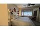 Bedroom with a bed, a ceiling fan, a bay window with blinds, and light-colored walls at 4732 S Adriano Way, Pahrump, NV 89061