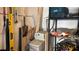 Utility area featuring shelves, water softener, and gardening tools neatly arranged against the wall at 4732 S Adriano Way, Pahrump, NV 89061