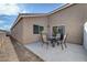 Backyard patio featuring a table and four chairs and view of home at 4841 Raw Umber Ct, Las Vegas, NV 89131