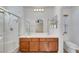 Bathroom featuring double sinks, a glass-enclosed shower, and vanity at 4841 Raw Umber Ct, Las Vegas, NV 89131