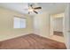 Bedroom featuring neutral walls, carpet, ceiling fan, and access to the bathroom at 4841 Raw Umber Ct, Las Vegas, NV 89131