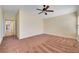 Bedroom with ceiling fan, neutral walls, and hallway access at 4841 Raw Umber Ct, Las Vegas, NV 89131