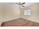 Bedroom with a ceiling fan, a window with blinds, and neutral carpeting at 4841 Raw Umber Ct, Las Vegas, NV 89131