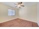 Bedroom with a ceiling fan, a window with blinds, neutral walls, and carpeting at 4841 Raw Umber Ct, Las Vegas, NV 89131