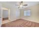 Bedroom featuring neutral walls, carpet, ceiling fan, closet, and access to the bathroom at 4841 Raw Umber Ct, Las Vegas, NV 89131