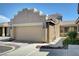 Tan home featuring a two-car garage, beautiful landscaping, and close up view of home number at 4841 Raw Umber Ct, Las Vegas, NV 89131