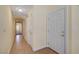 Hallway featuring tile flooring, neutral paint, and multiple doors, leading to various areas of the home at 4841 Raw Umber Ct, Las Vegas, NV 89131