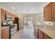 Bright kitchen features stainless appliances, tile backsplash, and sliding glass doors to the patio at 4841 Raw Umber Ct, Las Vegas, NV 89131
