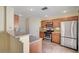 A modern kitchen featuring stainless steel appliances, light wood cabinets and recessed lighting at 4841 Raw Umber Ct, Las Vegas, NV 89131