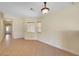 Tiled living room with an arched doorway, window, and modern lighting at 4841 Raw Umber Ct, Las Vegas, NV 89131