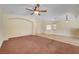 Bright living space with neutral walls, tile flooring, carpeted areas, and modern lighting at 4841 Raw Umber Ct, Las Vegas, NV 89131