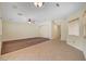 Spacious living room with neutral walls, tile flooring, carpeted areas, modern lighting, and a ceiling fan at 4841 Raw Umber Ct, Las Vegas, NV 89131