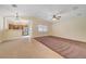 Open-concept living room with tile floors, a ceiling fan, and views of the kitchen at 4841 Raw Umber Ct, Las Vegas, NV 89131