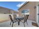 Charming outdoor patio with a table and four chairs, perfect for relaxing or entertaining guests at 4841 Raw Umber Ct, Las Vegas, NV 89131