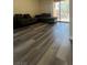 Bright living room with plank flooring and sliding glass doors to a balcony at 5000 Indian River Dr # 483, Las Vegas, NV 89103