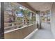 A condo balcony featuring outdoor living space with views of trees and an adjacent building at 5042 S Rainbow Blvd # 206, Las Vegas, NV 89118