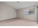 Neutral bedroom with a sliding door, large window, and plush carpeting at 5042 S Rainbow Blvd # 206, Las Vegas, NV 89118