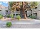 Charming condo complex featuring desert landscaping, multiple stories, and architectural details at 5042 S Rainbow Blvd # 206, Las Vegas, NV 89118
