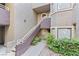 Exterior view of the condo with a staircase and well-maintained landscaping at 5042 S Rainbow Blvd # 206, Las Vegas, NV 89118