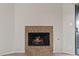 Close up of a tiled fireplace with mantle and glass doors at 5042 S Rainbow Blvd # 206, Las Vegas, NV 89118