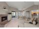 Inviting living room with cozy fireplace, plush carpet, and a dining area bathed in natural light at 5042 S Rainbow Blvd # 206, Las Vegas, NV 89118